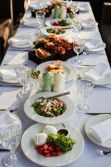 festive table with various dishes on a white tablecloth