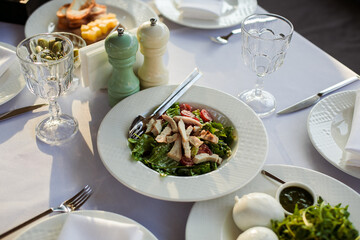 festive table with various dishes on a white tablecloth