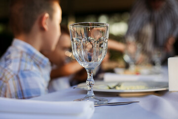 festive table with glasses and plates on a white tablecloth