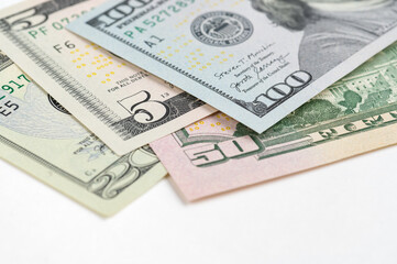 5, 20, 50, 100 dollars banknotes at different angles. Close up of dollars on white background.