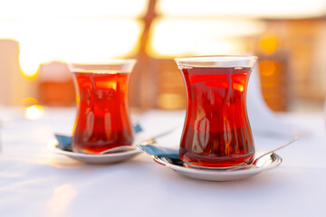 Two glasses with Turkish tea on white table