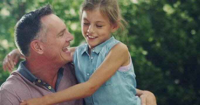 Family love between father and daughter, happy outside together and enjoying summer. Young and excited girl child running, hugging and loving her smiling single dad outside in the garden at home