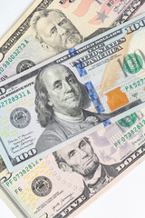 5, 20, 50, 100 dollars banknotes at different angles. Close up of dollars on white background.