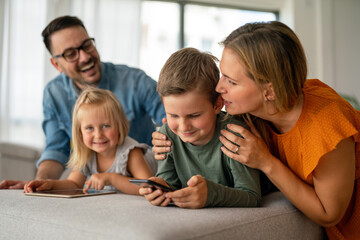 Device technology family online education concept. Happy family with digital devices at home.
