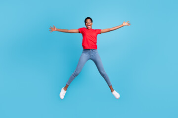 Fototapeta na wymiar Photo of charming excited short hair person dressed red t-shirt jumping high like star isolated blue color background