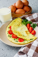 Omelet with dill filled tomatoes