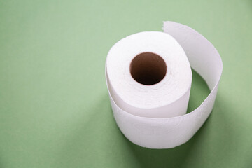 toilet paper from recycled materials. White toilet paper on green background. toilet paper in a roll, close-up. Recycled paper zero waste