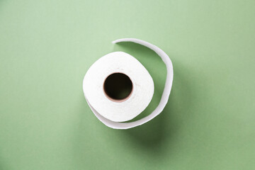 toilet paper from recycled materials. White toilet paper on green background. toilet paper in a...