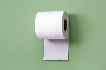 toilet paper from recycled materials. White toilet paper on green background. toilet paper in a roll, close-up. Recycled paper zero waste