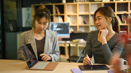 Two female IT developer working together for developing new software at corporate office