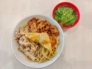 Noodle with chicken meat , pork meat, fried dumpling 
