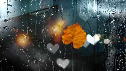yellow leaves and  rain drops on wet  window glass ,Rainy weather, pedestrian with umbrella ,  bokeh bluured night city light  ,Autumn season background template banner 