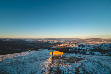 Bench on Mount Ochodzita in the Koniakow area of the Polish Beskydy Mountains illuminated in the morning light. Beautiful quiet resting place