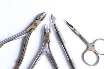 Cuticle pusher, cuticle trimmer. nail trimmer and purpose scissors isolated on a white background....