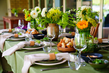 beautiful setting of a large table with flowers. 