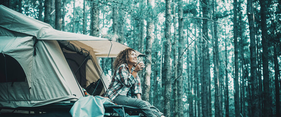 Travel and freedom lifestyle people concept. Happy woman sit and enjoy relax on the roof tent car....