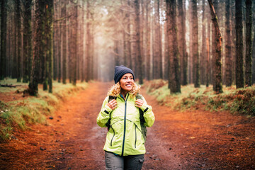 One young woman with a backpack in outdoor excursion leisure activity at the park. Female enjoying...