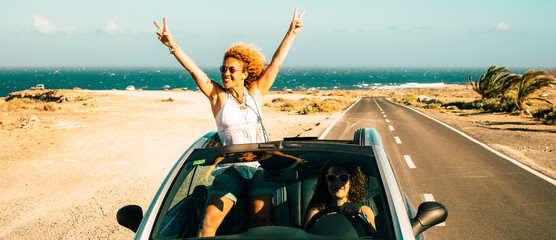 Travel with car vehicle and tourists summer destination concept. Happy and excited couple of women...