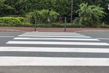 pedestrian crossing on the road for safety when people cross the street, pedestrian crossing on the repaired asphalt road