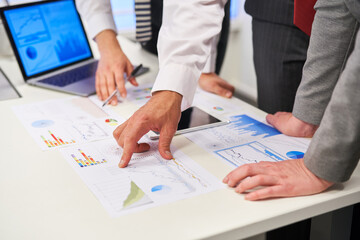 Business people in meeting analyzing graphs