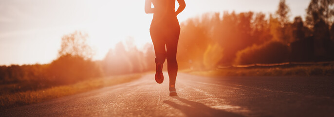 Woman running outdoors on the evening sunset.