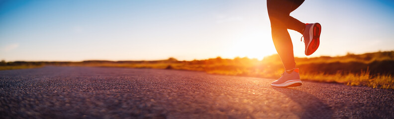 Woman running outdoors on the evening sunset.