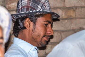 a laborer is working at a construction site and wearing a hat