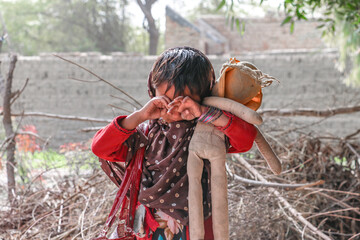 a young girl is crying cause of war and walking alone 
