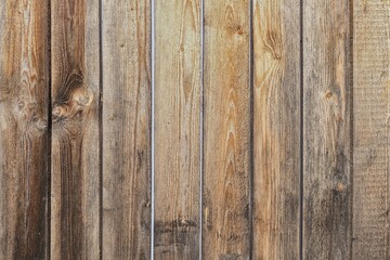 Threadbare clapboards texture. Old weathered shabby outside wall of rustic barn covered with vertical worn wooden planks for texture or background. 