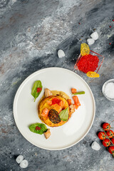 Potato pancakes with red caviar, red fish and mushroom sauce. banner, menu, recipe place for text, top view