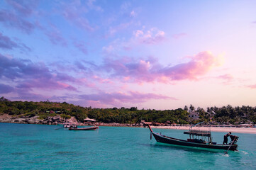 Naklejka na ściany i meble Travel by Thailand. Beautiful tropical beach with traditional longtail boat.