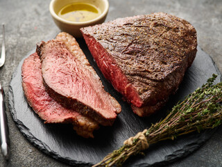 Grilled sliced cap rump steak with salt on wooden cutting board. Marble meat beef (Brazilian picanha) - 520763401