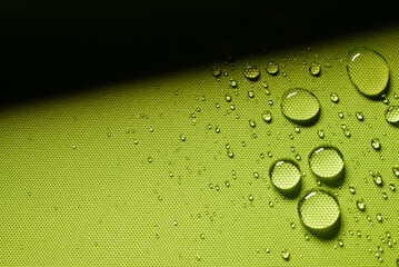 Green textile with water drops