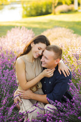 Beautiful couple in love hugging in lavender field