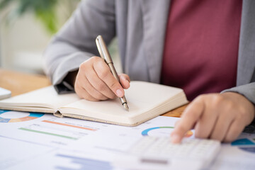 Businesswoman Accountant analyzing investment charts Invoice and pressing calculator buttons over documents. Accounting Bookkeeper Clerk Bank Advisor And Auditor Concept