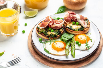 Delicious breakfast or snack. Grilled Toast witch Asparagus, fried egg, bacon jamon, ham, prosciutto on dark background. Healthy fats, clean eating for weight loss. Long banner format. top view