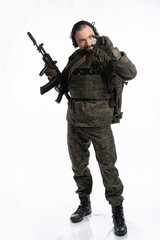 soldier in the studio on a white background. a man in military uniform with a rifle or machine gun. military or airball player