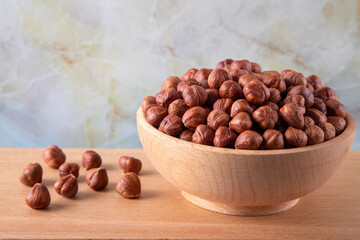 Bowl full of hazelnuts  on wooden background