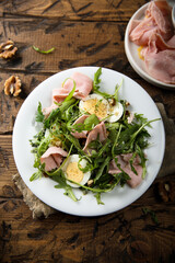 Arugula salad with ham and egg