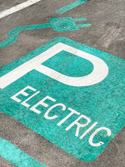 The logo sign of an electrical vehicle parking spot inside a shopping center. Eco electric cars industry.