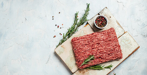 Fresh Raw Beef Minced Meat on a light background. Food recipe background. Close up. Long banner format. top view