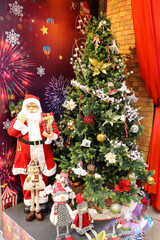 christmas card. Christmas tree, a small house and a figurine of Santa Claus