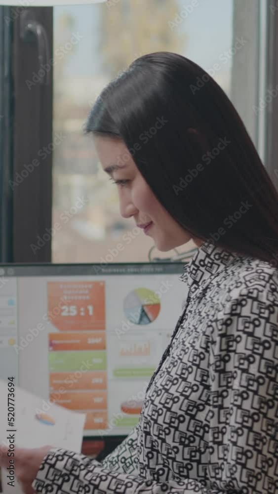 Poster vertical video: close up of business woman analyzing financial documents to design data charts on co