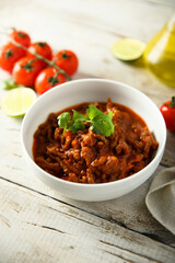 Homemade beef ragout with cilantro and lime