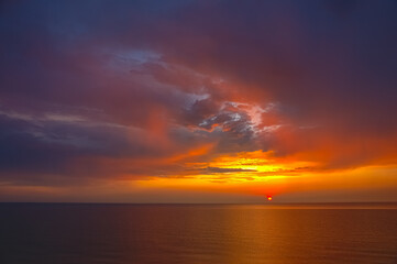 Colorful sunset at the Baltic Sea. Swimming couple in a bright sunset. 