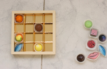 Chocolate candirs on white background. Flat lay, top view composition with copy space. Flatlay mockup made of multi-colored candy.