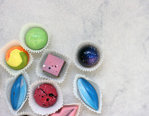 Chocolate candirs on white background. Flat lay, top view composition with copy space. Flatlay mockup made of multi-colored candy.