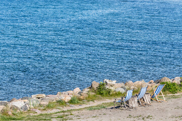 Fototapeta na wymiar deck chairs facing waters of Oresund sea, Helsingor, Denmark