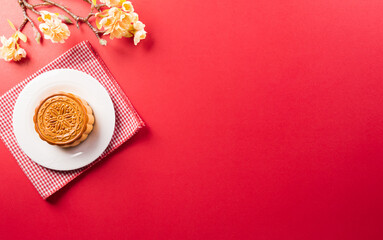 Chinese Mid-Autumn Festival concept made from mooncakes, tea and plum blossom.