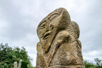 This is a bronze age stone carviing with two faces,called Janus, located In Caldragh Cemetery on Boa Island, Lower Lough Erne. Northern Ireland